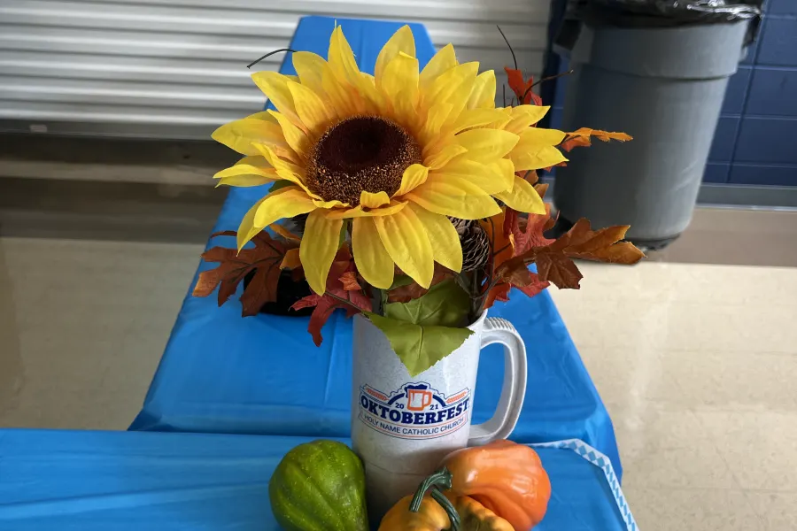 A sunflower and pumpkin fall centerpiece on a festival table