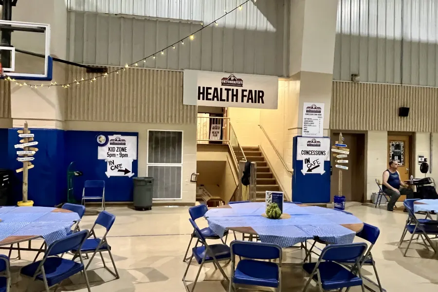 Tables and information booths at the Friday health fair in the school gym